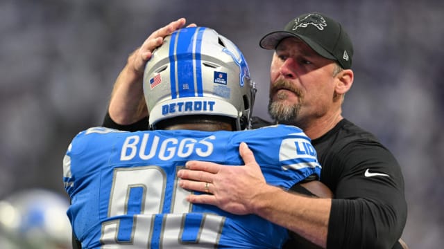 Detroit Lions coach Dan Campbell embraces defensive tackle Isaiah Buggs.